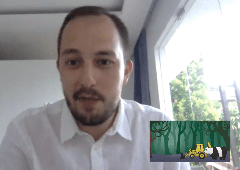 Stuart, a white man with black hair and facial hair, in a white shirt, sits at his computer to talk to us on our podcast. Superimposed on the photo is a screenshot from his Sustainability Challenge video, showing a cartoon digger and panda in a forest setting.