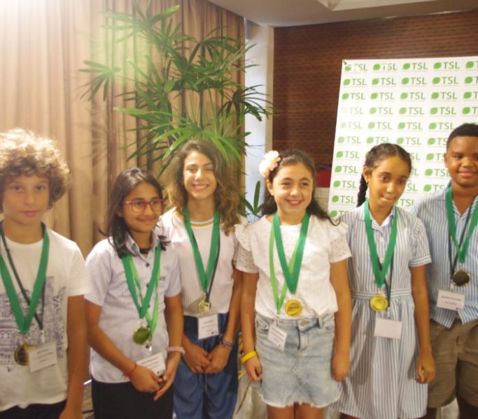 Group photo of 6 students with medals